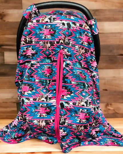 AZTEC PRINTED CARSEAT COVER W/ORANGE SOFT FABRIC.